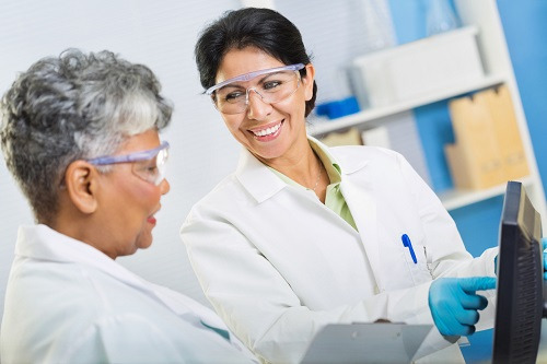 two women researchers viewing a computer screen