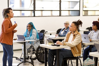 image of an instructor teaching in a diverse classroom